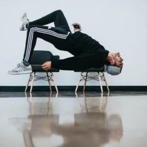 man sitting on chair near wall